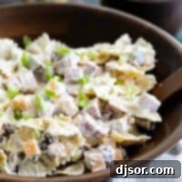 bowl with pasta salad with ingredients in the back