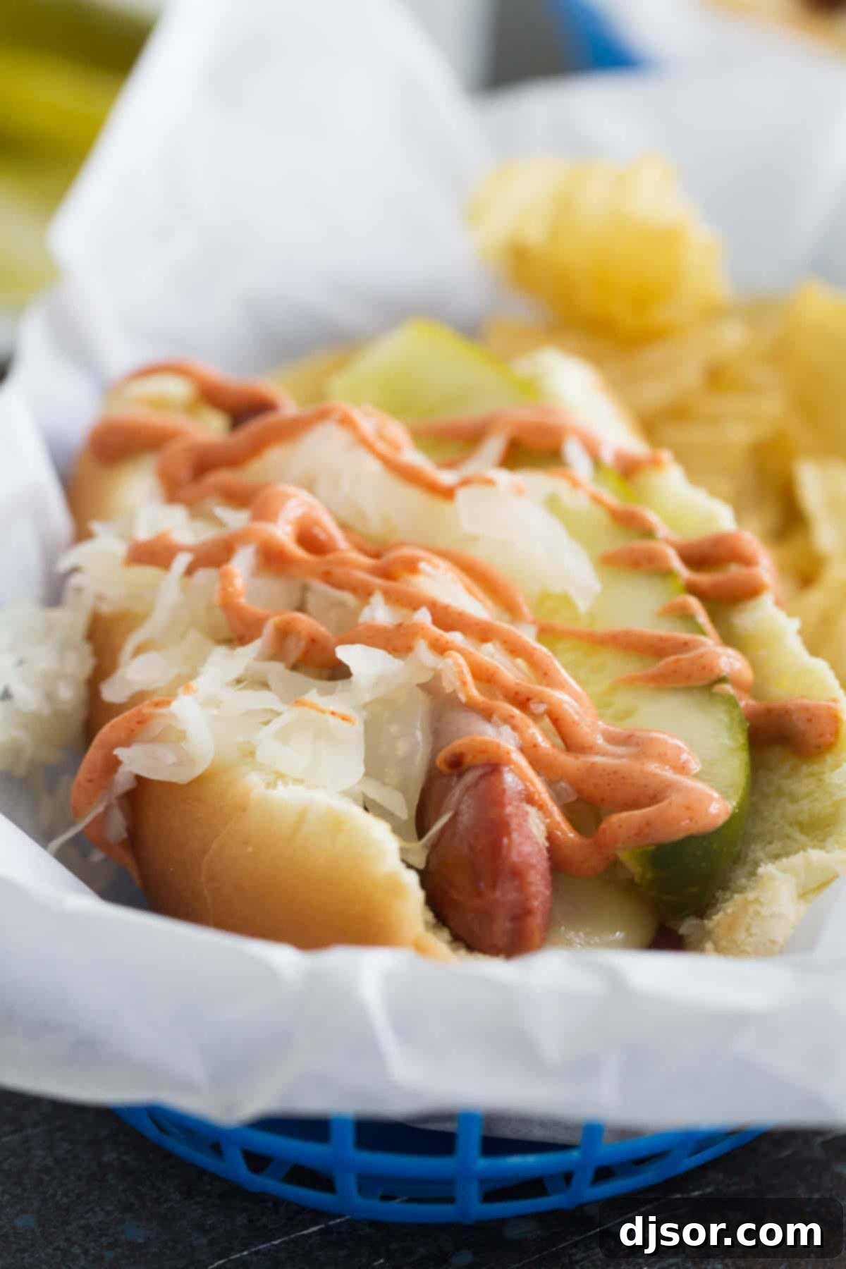 Hot dog with sauerkraut, pickle, and homemade Russian dressing