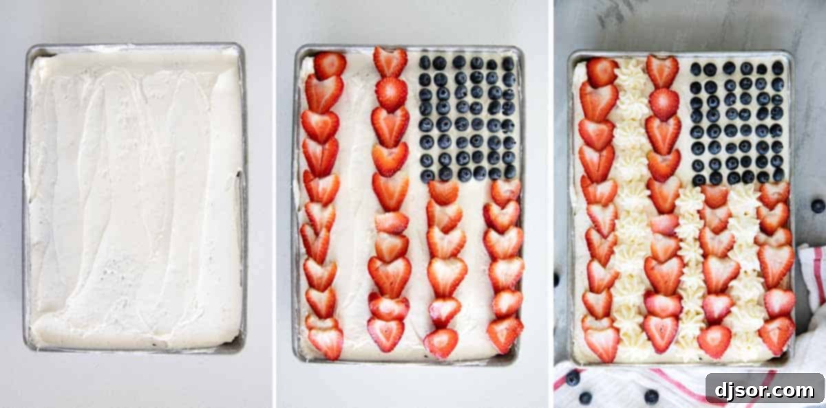 Overhead view of a flag cake being decorated with blueberries and strawberries.