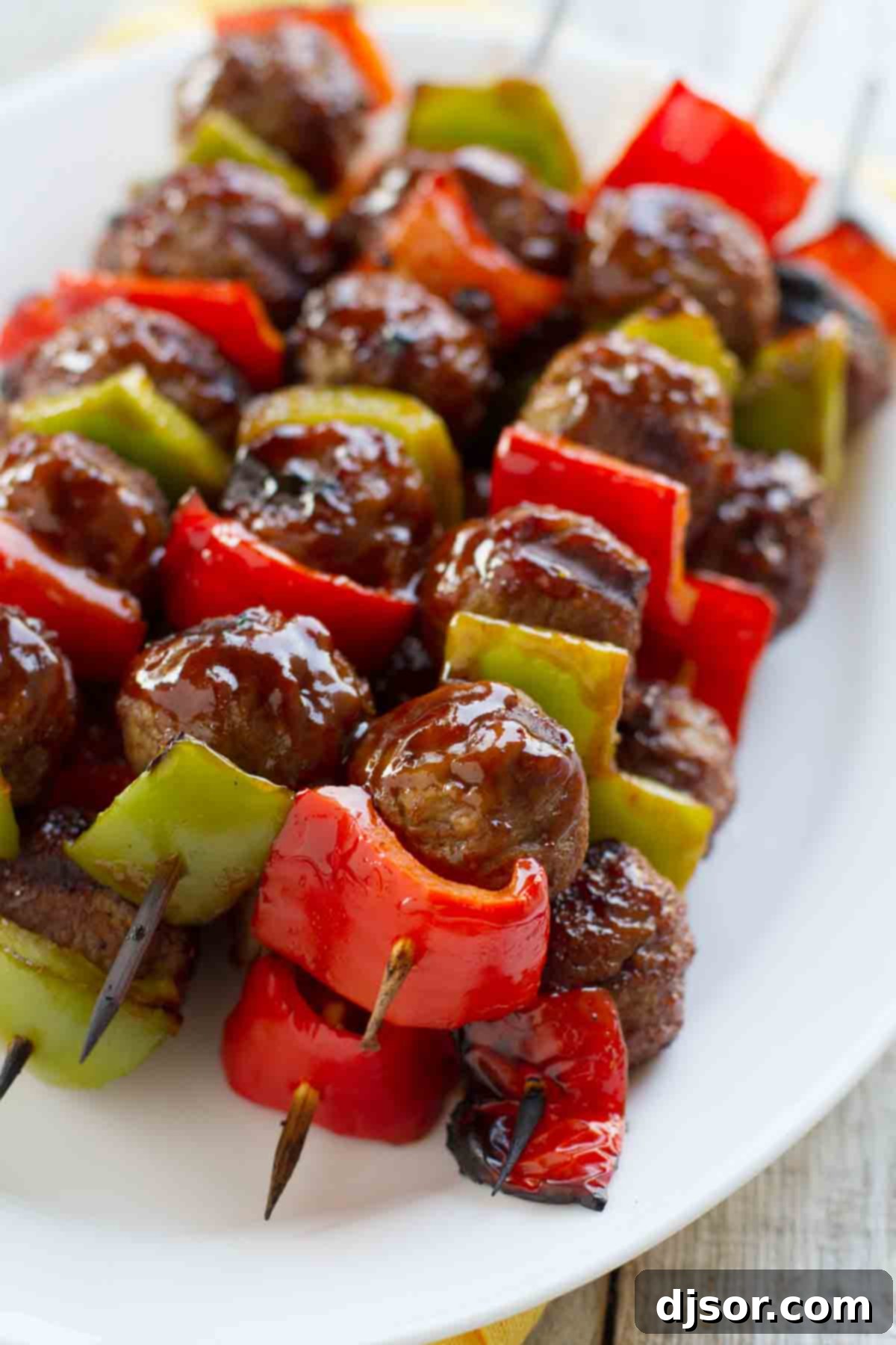 Easy Sweet and Sour Meatball Skewers with frozen meatballs and fresh peppers Sweet and Sour Meatball Skewers stacked on a plate, showcasing a delicious appetizer or main course.