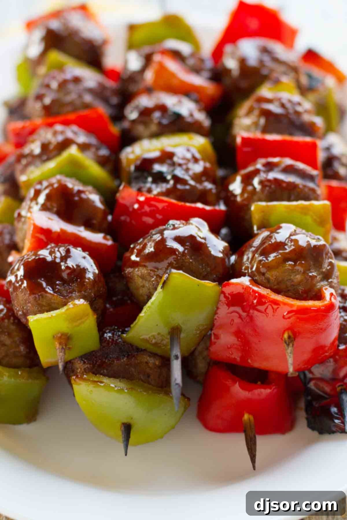Delicious grilled meatball and pepper skewers Grilled meatballs with colorful bell peppers basted with a sweet and sour sauce.