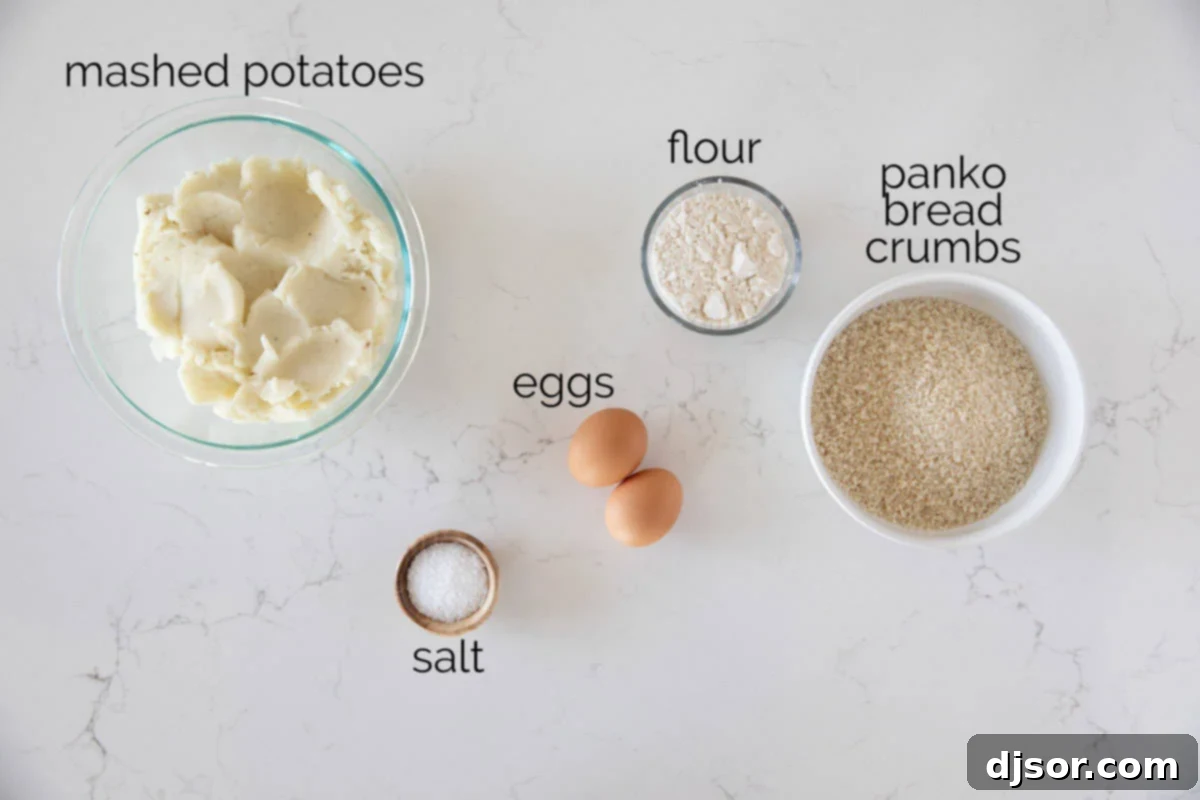 A flat lay photograph showcasing the simple ingredients required to make Homemade Tater Tots: cold mashed potatoes, eggs, flour, salt, panko breadcrumbs, and a bottle of cooking oil.
