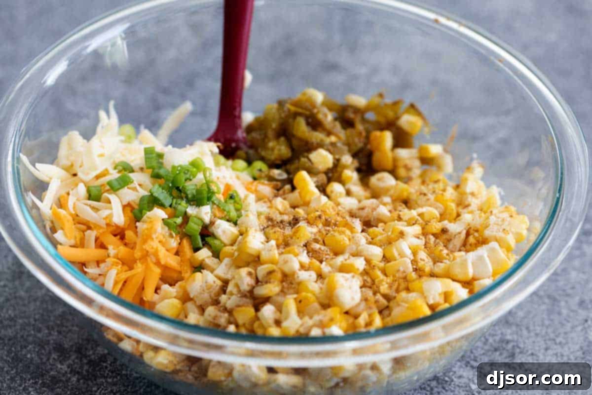 Fresh ingredients for creamy corn dip including corn, mayonnaise, sour cream, and green chiles.