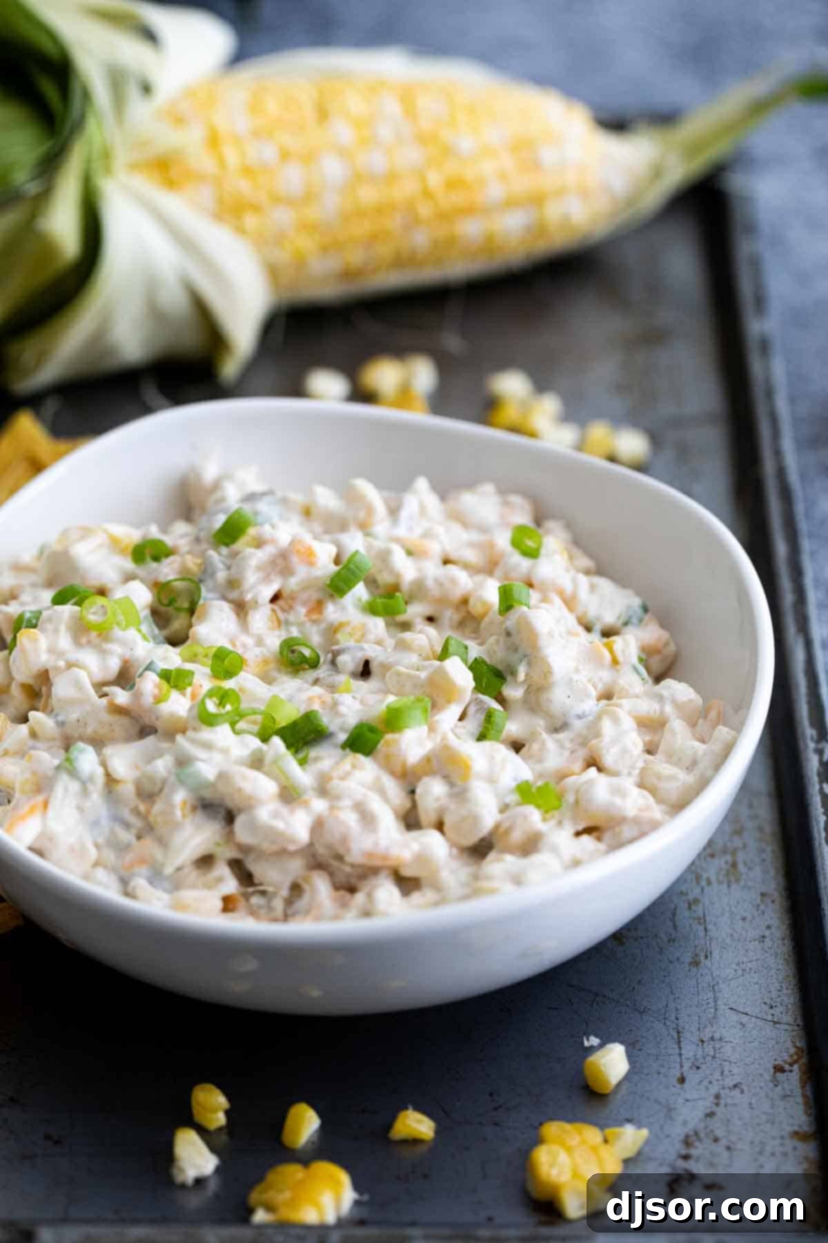 Creamy 'Crack' Corn Dip with fresh corn and green chiles, ready to serve.