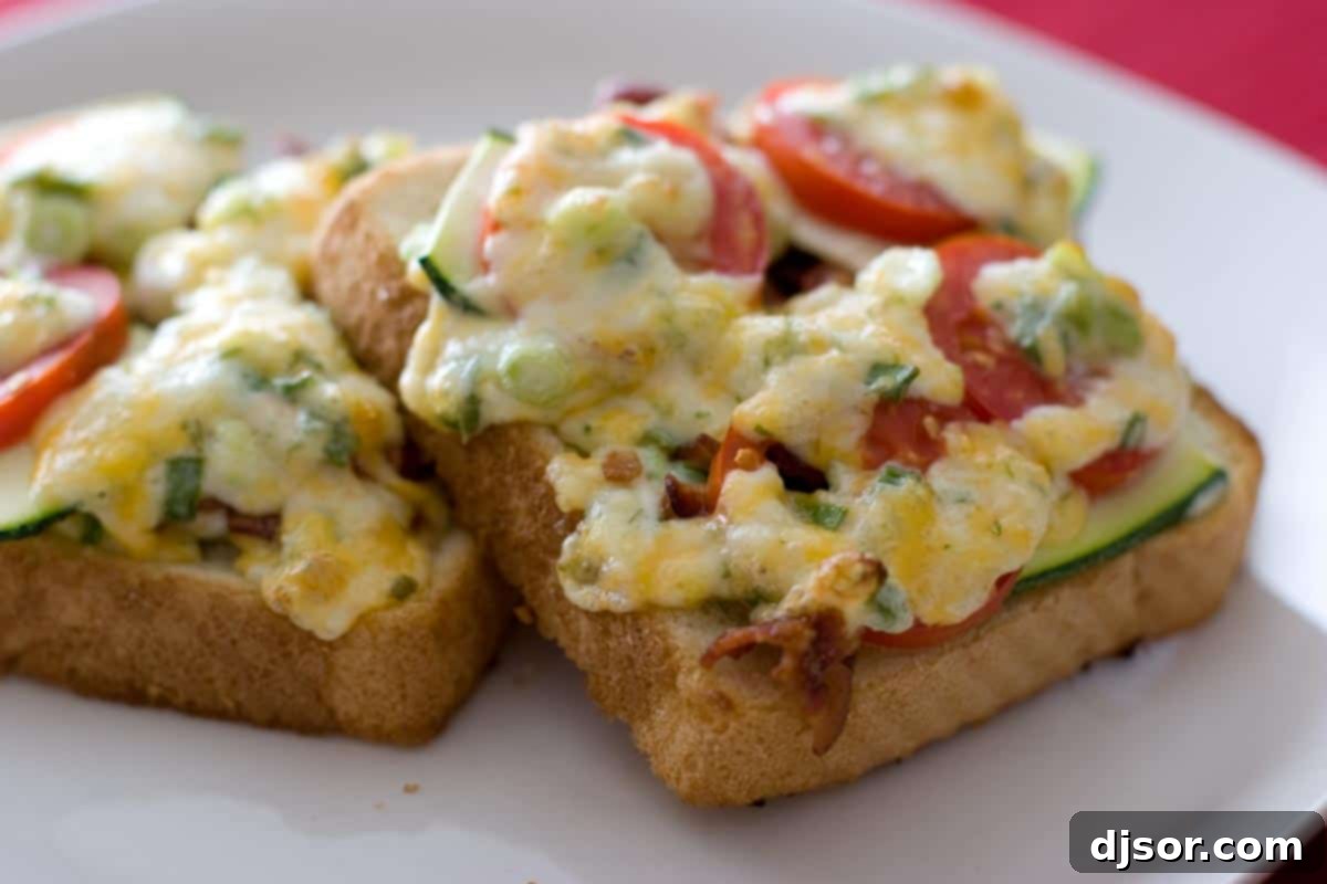 Bacon Tomato Cheese Toasts - This ultimate open faced sandwich is covered with cheese, bacon, tomatoes and zucchini. slices of bread topped with tomato, zucchini, bacon and melted cheese