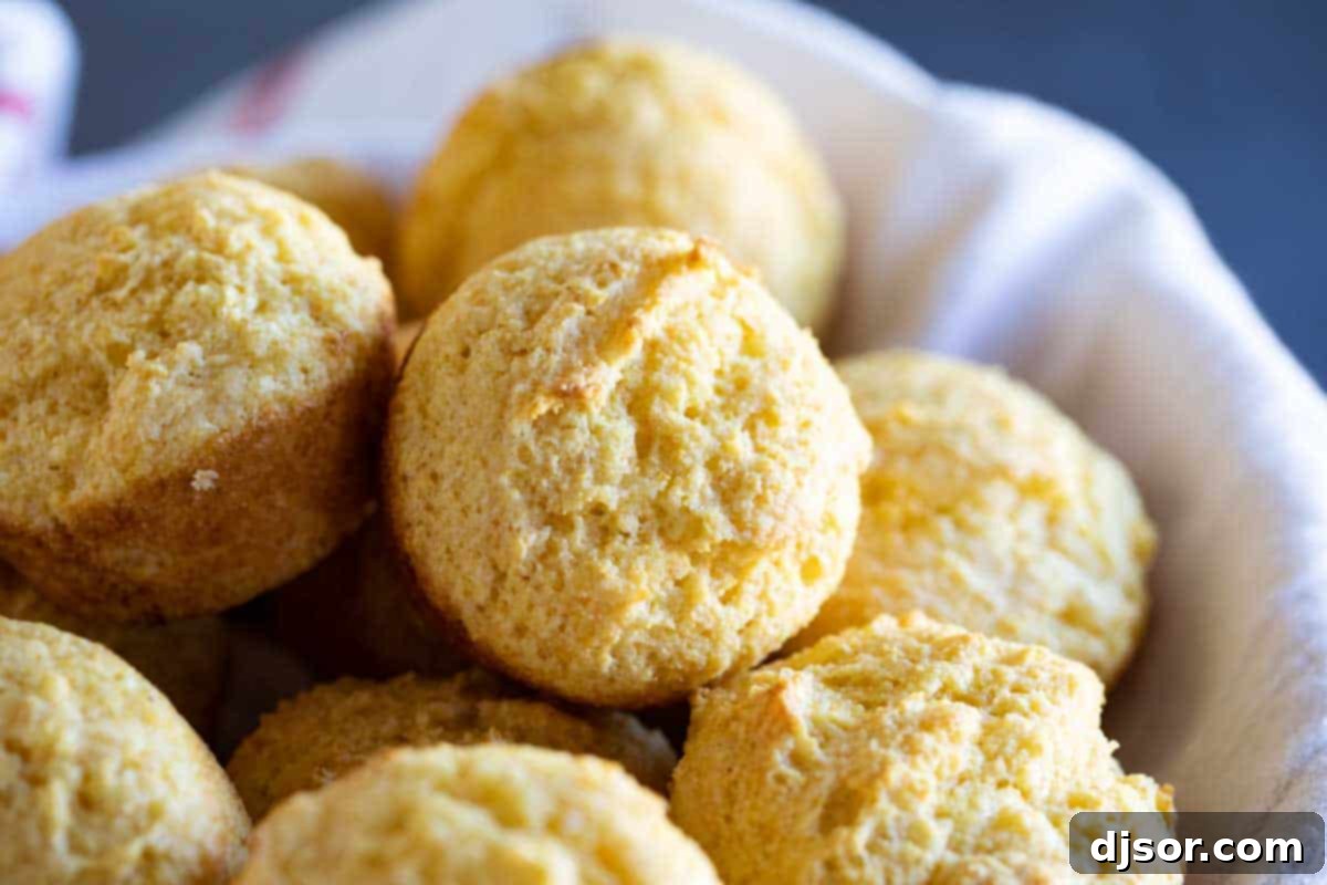 The Best Moist Corn Muffin Recipe A charming basket filled with golden-brown, perfectly baked corn muffins, showcasing their tender texture.