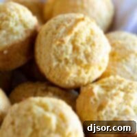 Golden Corn Muffins 2 A stack of warm corn muffins wrapped in a kitchen towel