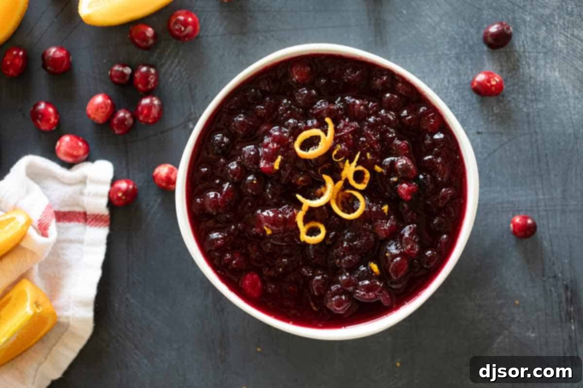 An inviting overhead shot of a bowl filled with vibrant red homemade cranberry sauce, highlighting its rich texture and festive appeal.