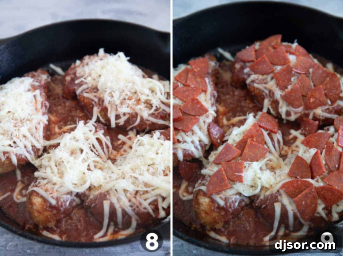 Close-up of crispy chicken cutlets in a skillet, topped with melted mozzarella, parmesan, and chopped pepperoni, ready for the oven.