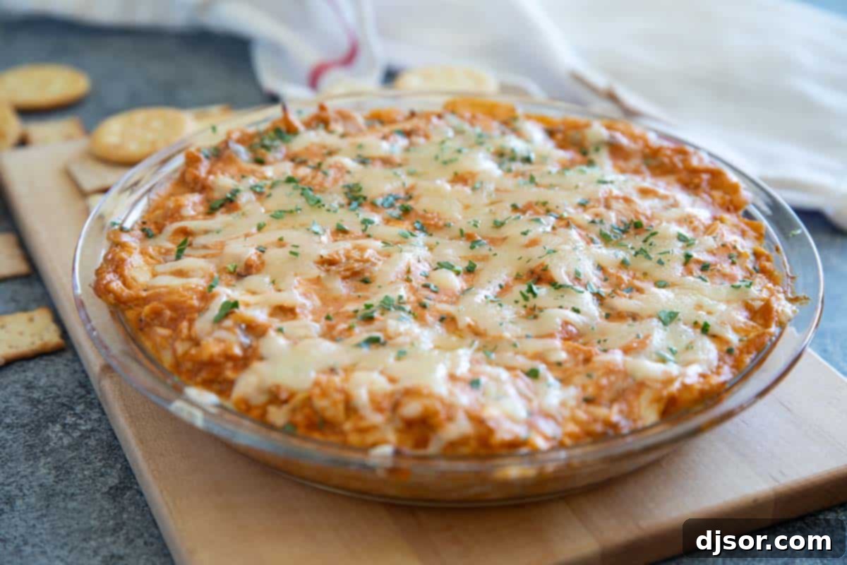 BBQ Chicken Dip in a glass pie plate, topped with melted cheese.