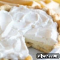A freshly made Banana Cream Pie with a slice removed, revealing the delicious layers of banana and creamy filling.