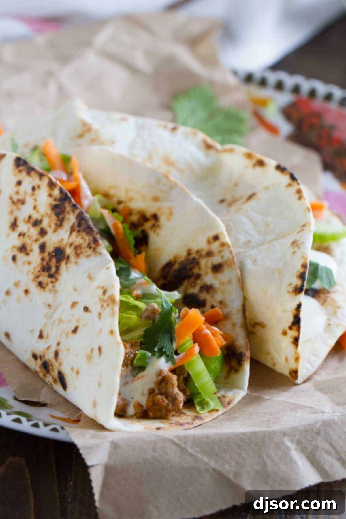 Close-up of ground beef mixed with buffalo sauce, ready for taco filling.