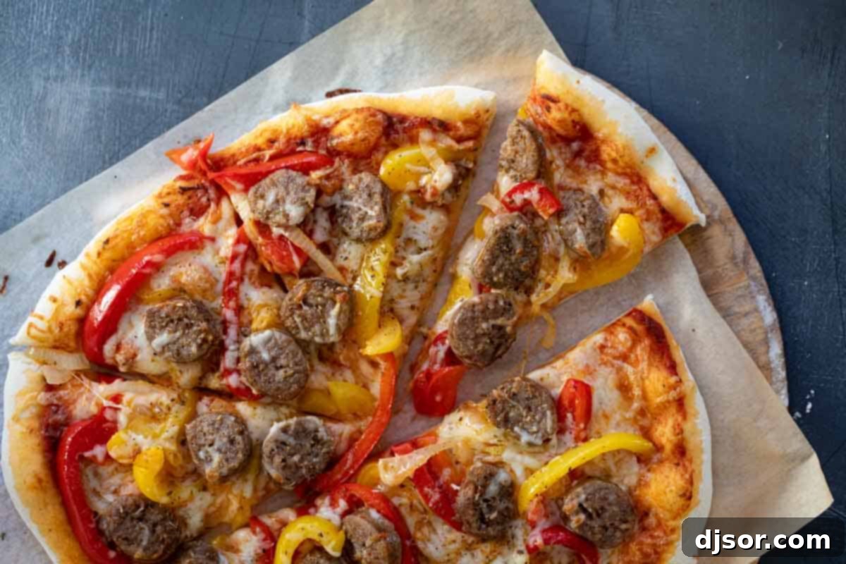 Sausage and Peppers Pizza for Family Dinner A whole freshly baked Sausage and Peppers Pizza, ready to be sliced, with a crispy crust and perfectly cooked toppings.