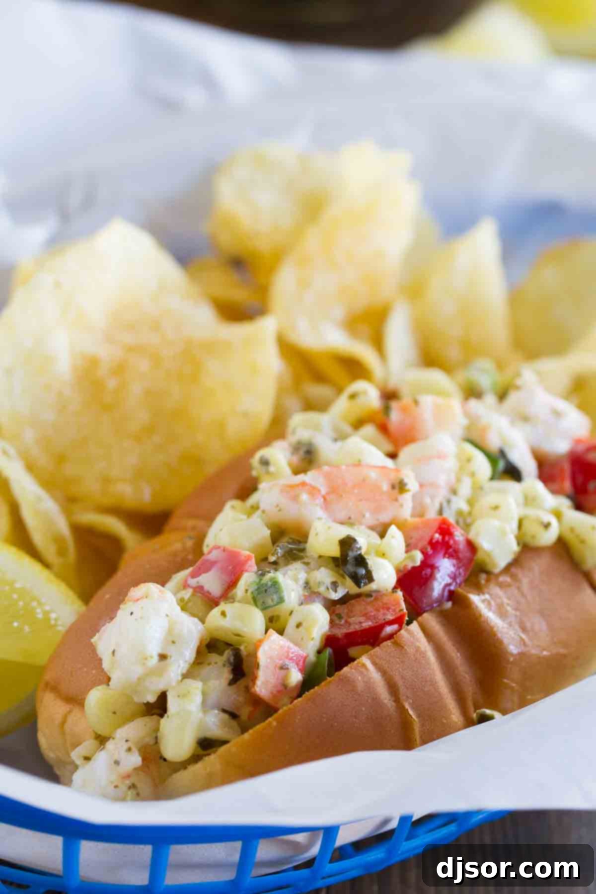 A beautifully presented shrimp roll filled with a colorful mix of shrimp, corn, red peppers, and green onions, nestled in a toasted bun.