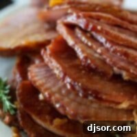 Effortless Slow Cooker Glazed Ham 2 slices of ham stacked on a serving plate