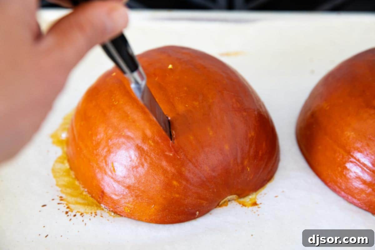 Testing a roasted pumpkin with a knife to check for tenderness