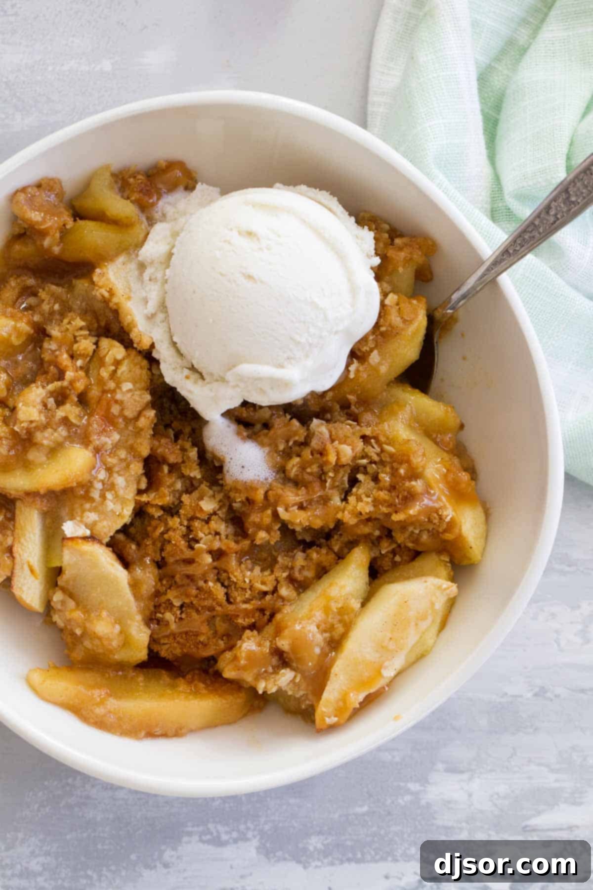 Caramel Apple Crisp topped with vanilla ice cream and caramel.