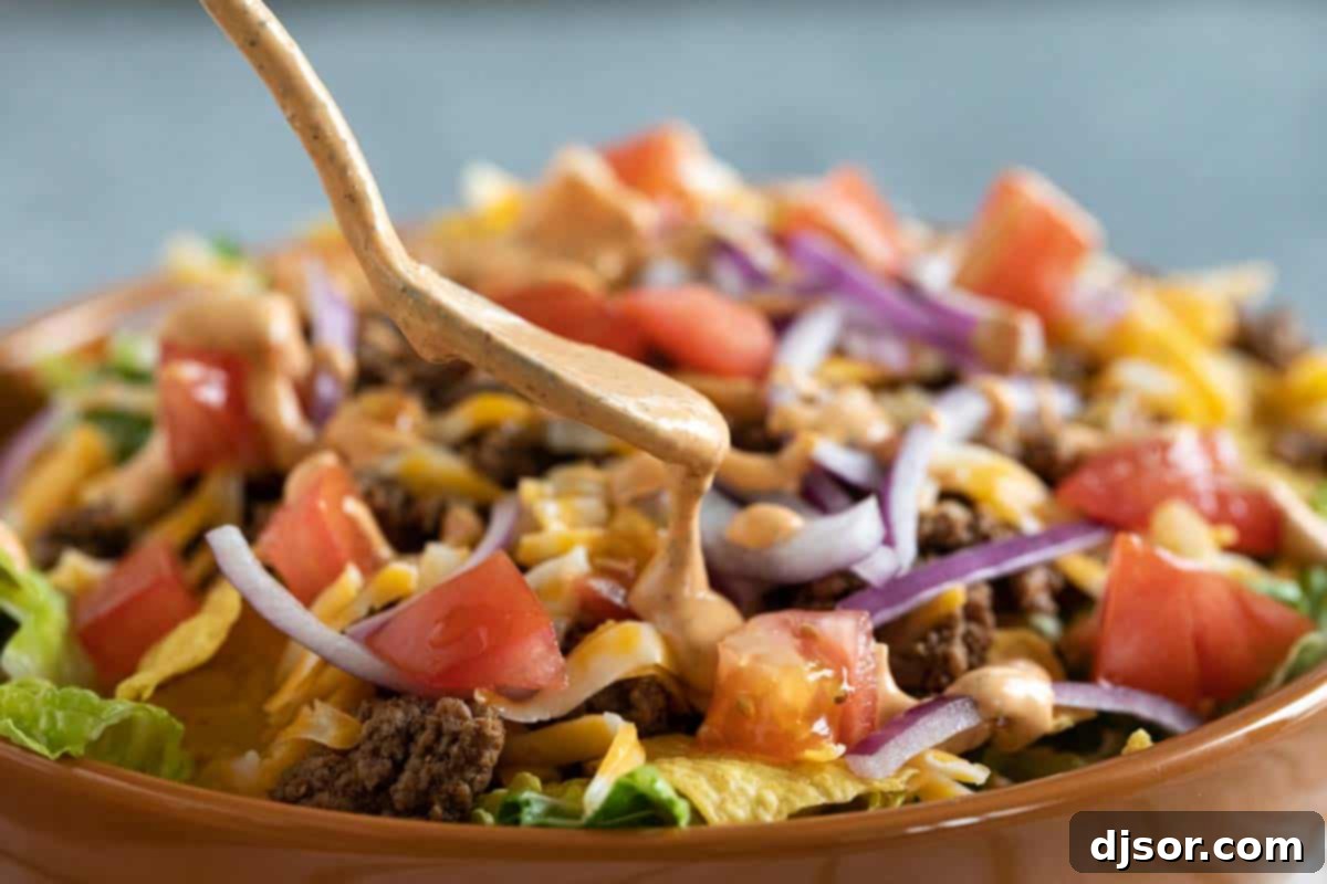 Perfect for Salads Hand drizzling creamy Chipotle Ranch Dressing generously over a fresh, colorful salad with various greens and vegetables.