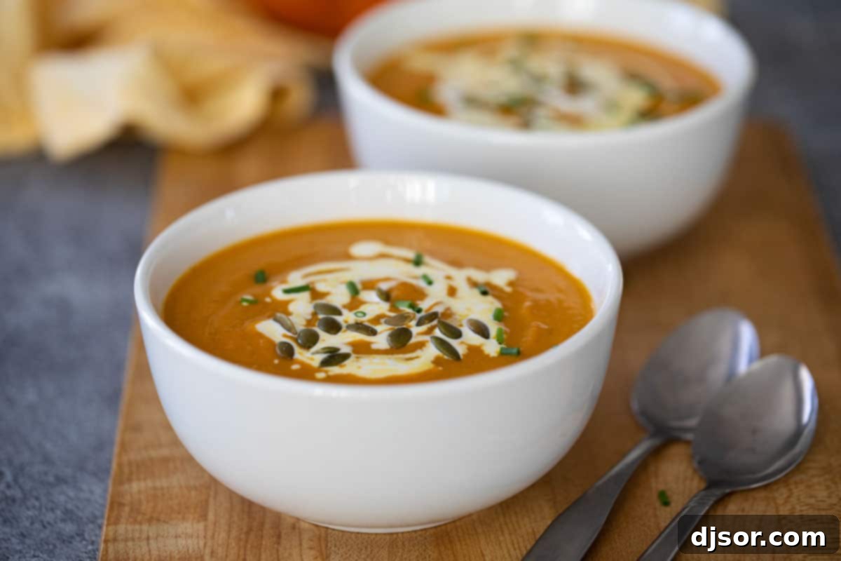 pumpkin soup topped with sour cream and pepitas