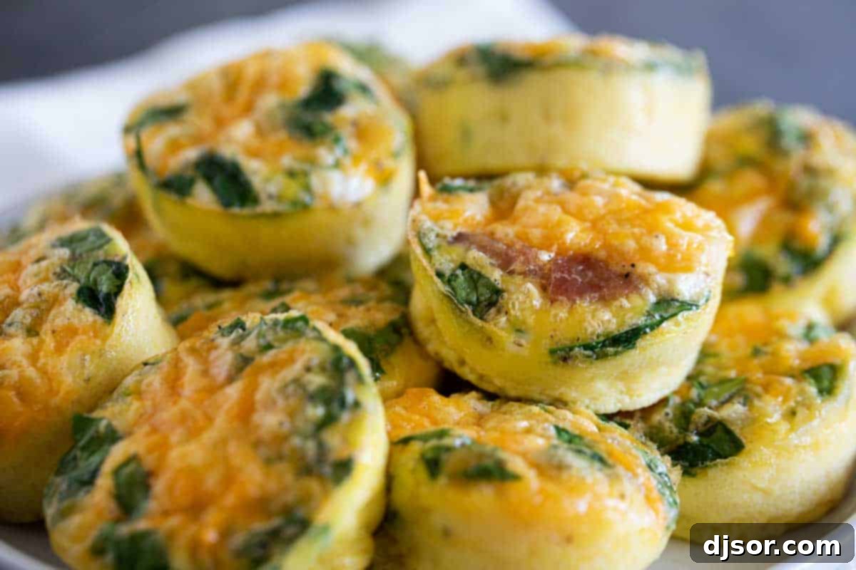 A great make ahead or breakfast on the go, these Egg Muffins and super simple, and super versatile! Egg Muffins stacked on a plate, ready to be enjoyed as a simple and versatile breakfast option.