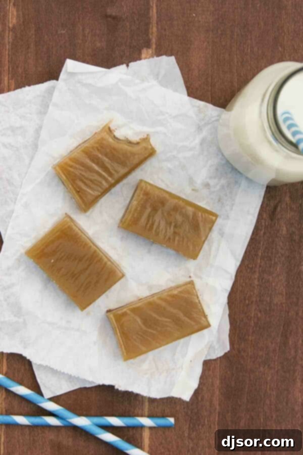 Close-up of 4 Chocolate Caramel Bars, with one showing a bite revealing the delicious cookie, chocolate, and caramel layers.