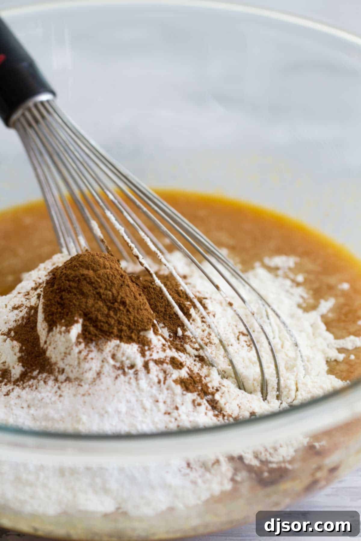 Mixing together ingredients for Cream Cheese Pumpkin Bread in a large bowl.