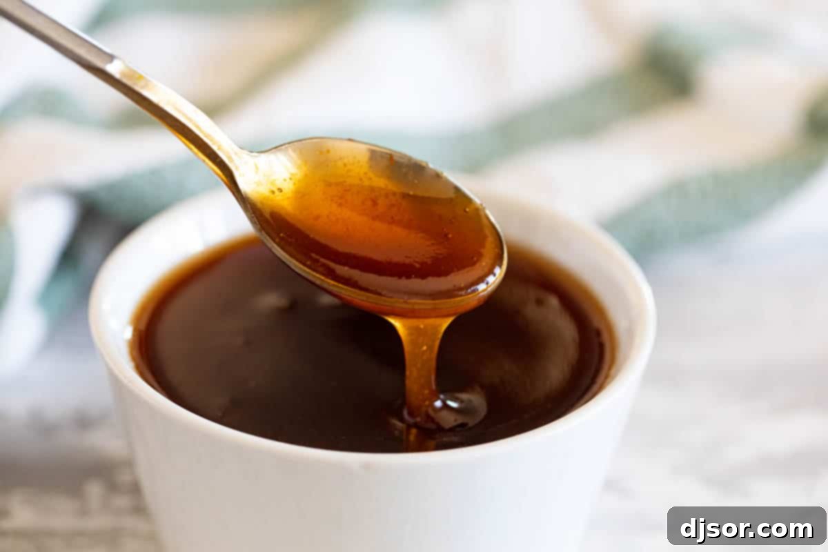 Skip the jarred version, and make it at home! This Sweet and Sour Sauce is so easy, and you probably have all of the ingredients on hand already! sweet and sour sauce in a small bowl with a spoon