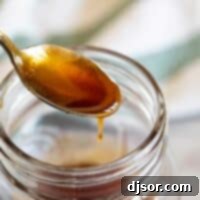 Sweet and Tangy Sauce 2 spoon full of sweet and sour sauce out of a jar