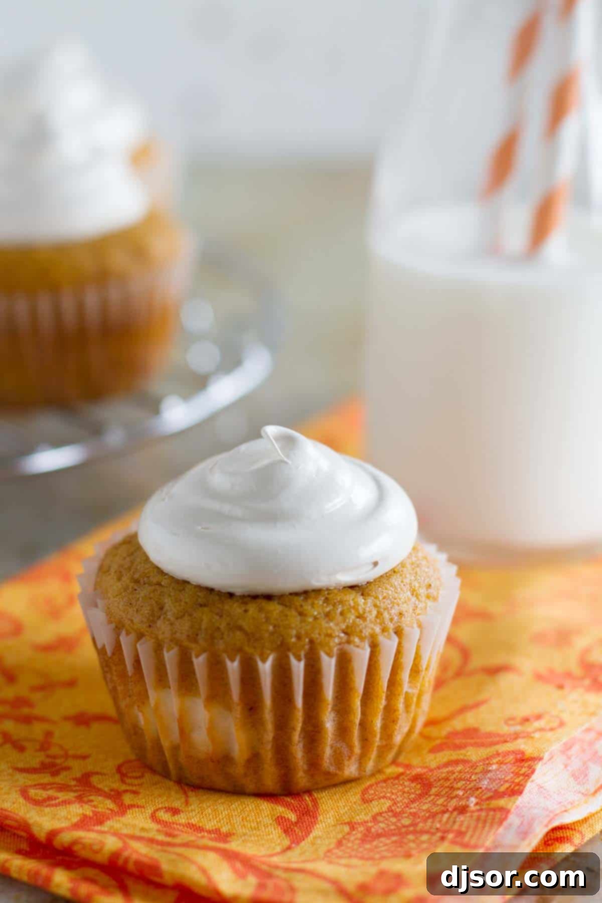 Pumpkin Cheesecake Cupcakes topped with swirling brown sugar marshmallow frosting, ready to be enjoyed.