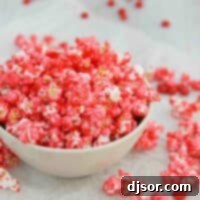 Sizzling Popcorn 2 bowl filled with Red Hot Popcorn with red hot candies around