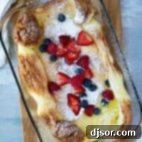 top view of Dutch baby in a glass baking dish with berries