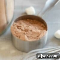 Measuring cup filled with homemade hot chocolate mix.