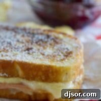 Monte Cristo Croque Monsieur 5 A mash up of 2 favorite sandwiches - a ham and cheese sandwich is slathered with a béchamel sauce, then battered and cooked in a skillet Monte Cristo style. Top with powdered sugar and raspberry jam if desired!