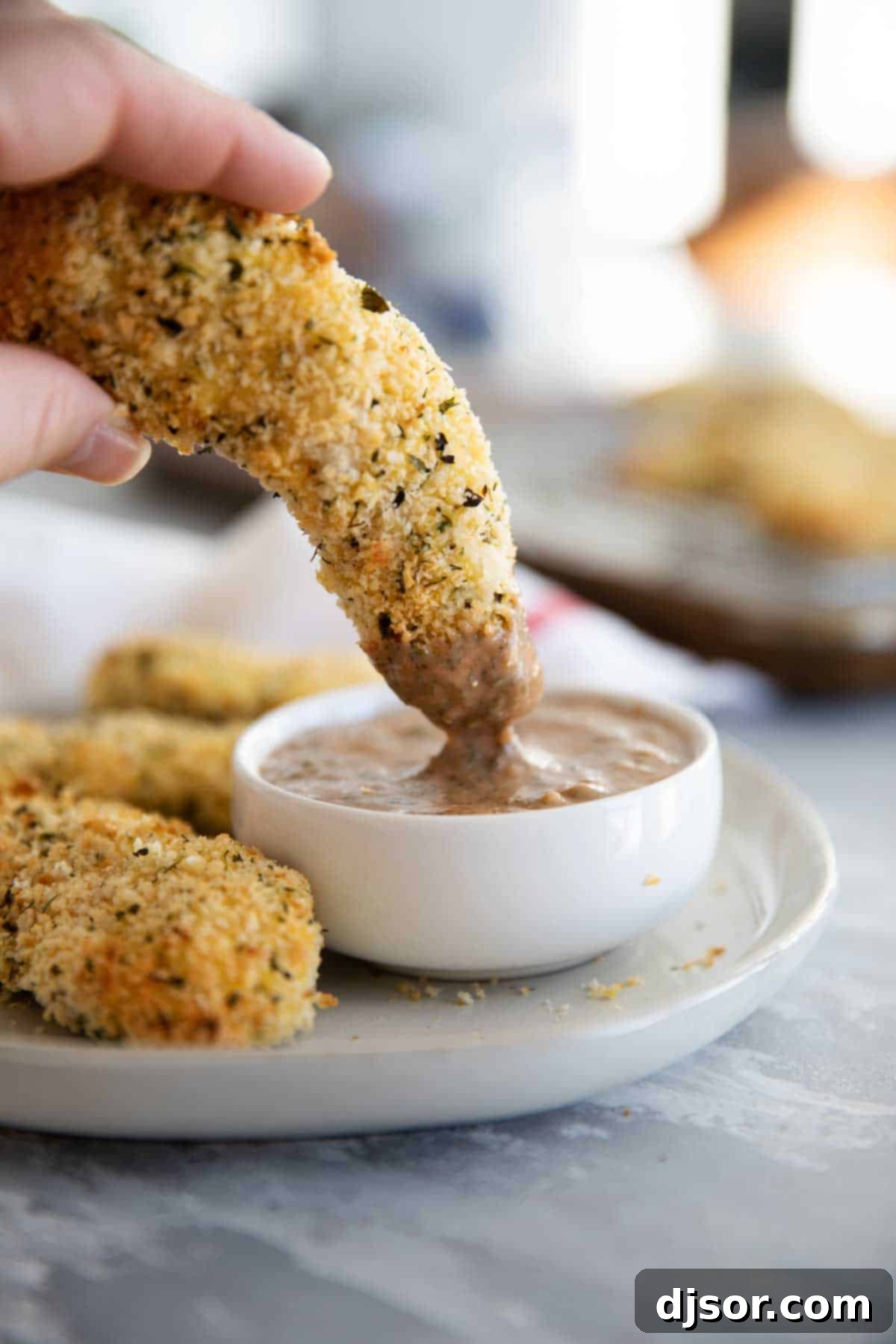 Zesty Ranch BBQ Dipping Sauce: The Perfect Companion for Chicken Strips Homemade Ranch BBQ Dipping Sauce served with crispy chicken strips.