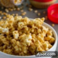 Peanut Butter Swirl Popcorn 2 Bowl of peanut butter popcorn with more popcorn in the background.