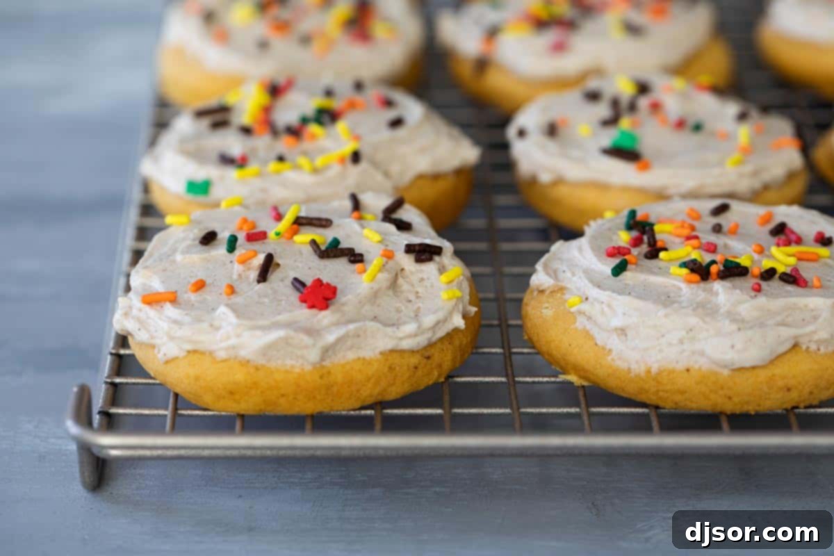 soft sugar cookies with pumpkin topped with maple cinnamon buttercream and sprinkles