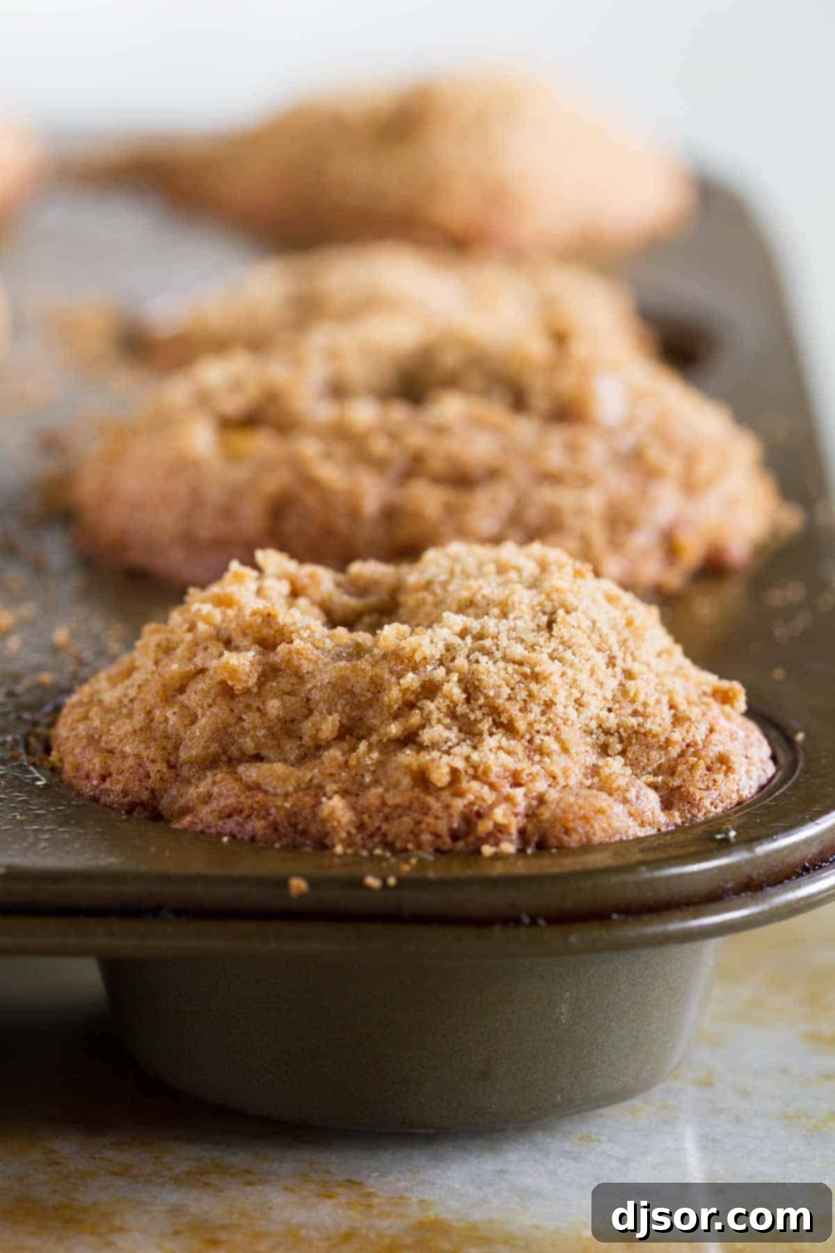 Apple cinnamon muffins in a muffin tin