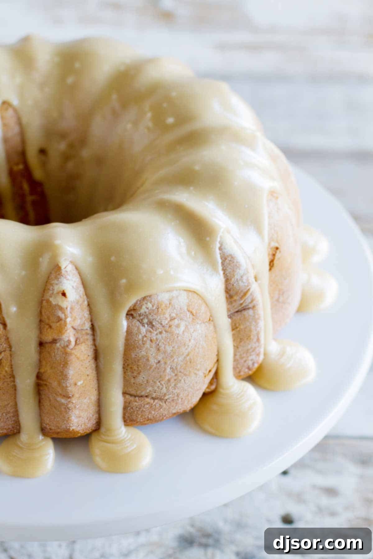 full Apple Bundt Cake with Caramel Frosting dripping down the sides