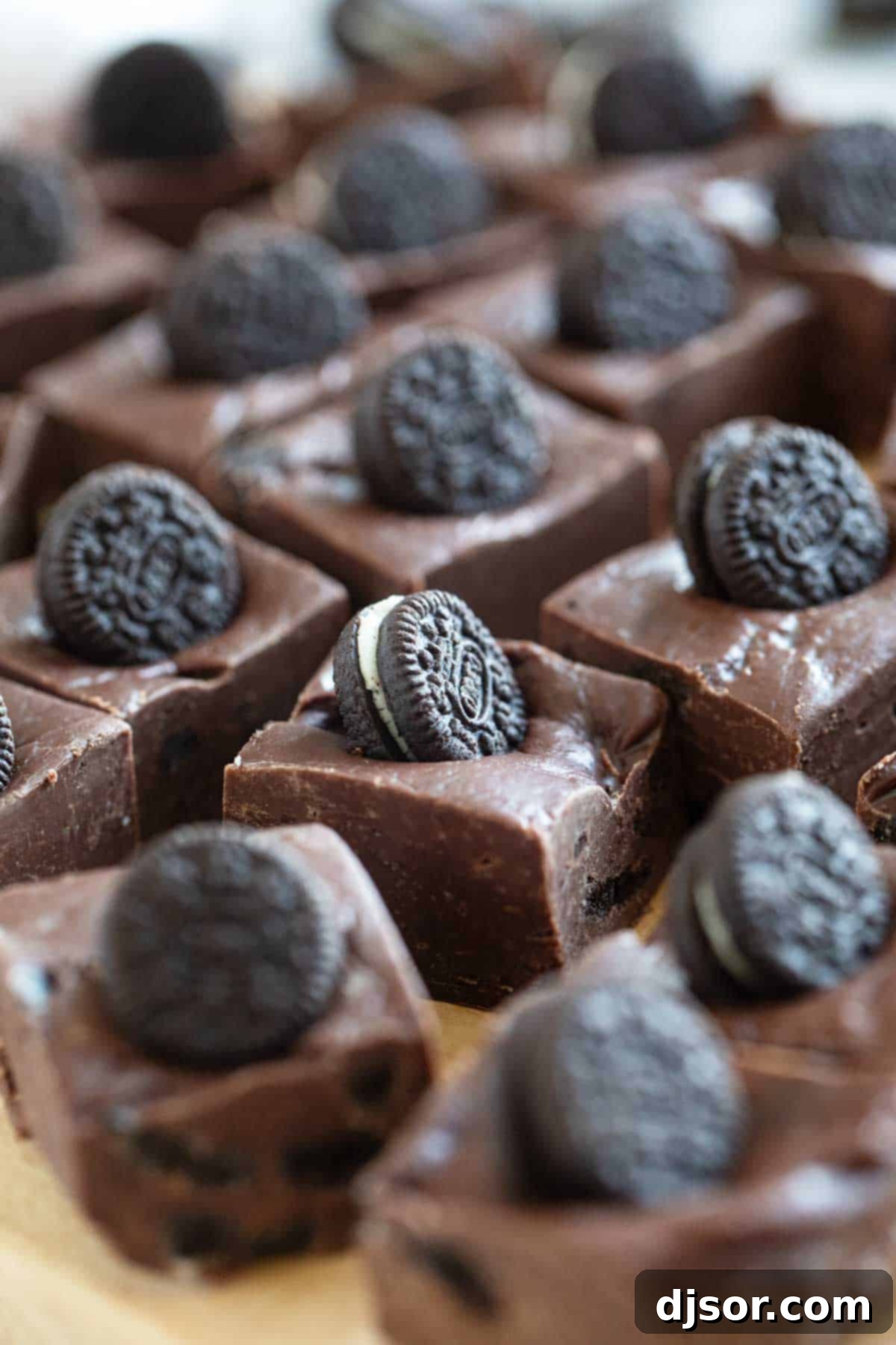 Ultimate Oreo Fudge Delight 6 Several squares of Oreo Fudge, each perfectly topped with a mini Oreo cookie, arranged enticingly.