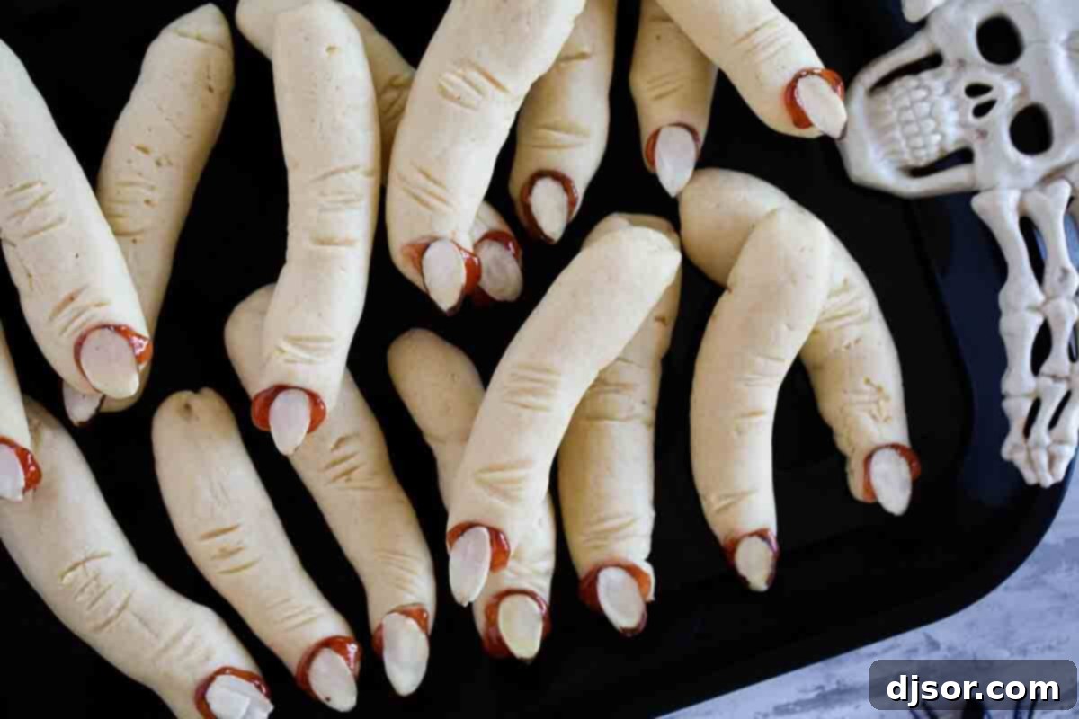 Creepy and Delicious Witch Finger Cookies for Halloween Witch Fingers - shortbread cookies shaped like fingers, topped with almonds for fingernails.