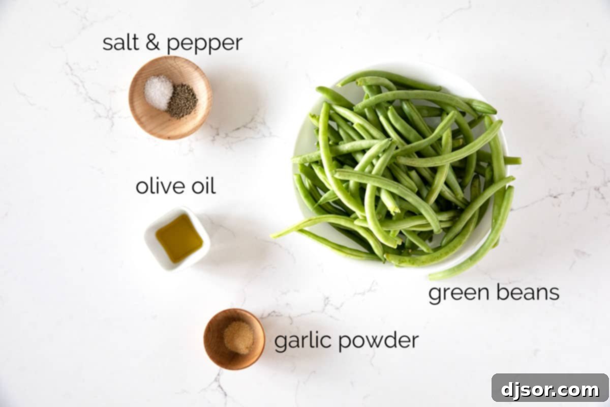 Essential ingredients for easy Air Fryer Green Beans. Fresh ingredients for Air Fryer Green Beans including green beans, olive oil, garlic powder, salt, and pepper laid out.