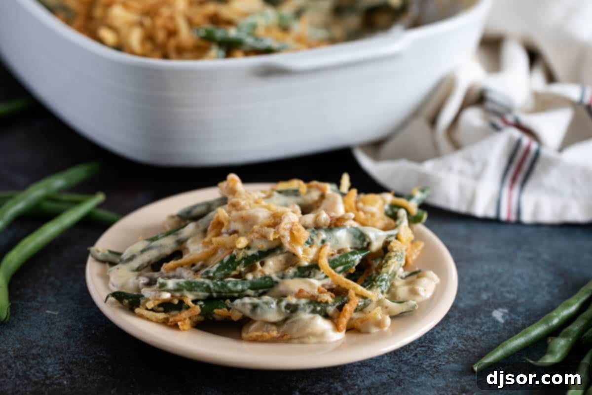 A beautifully prepared plate of homemade green bean casserole, generously topped with golden crispy onion strips, ready to be enjoyed.