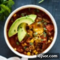 Your New Favorite Taco Soup 2 Taco Soup Recipe in a bowl topped with slices of avocados.