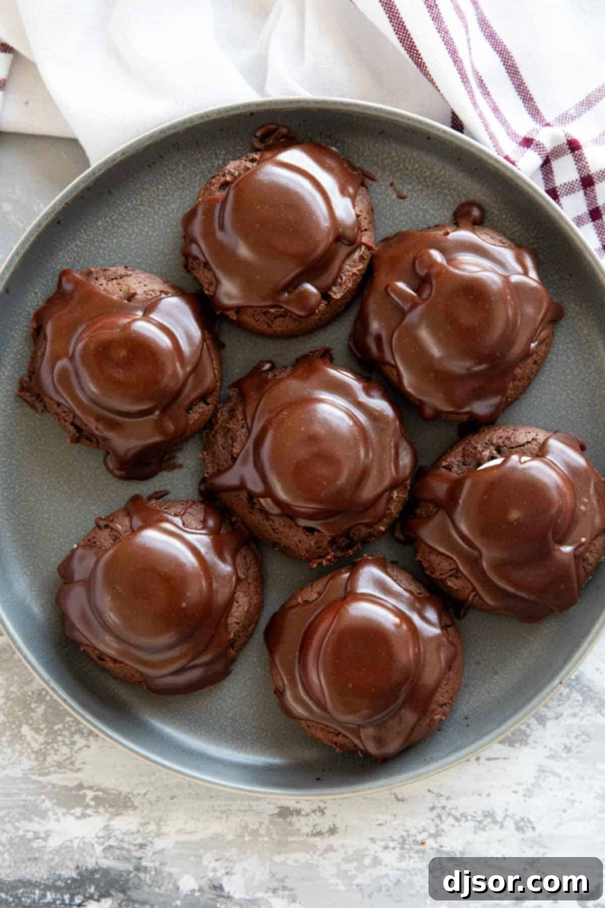 Seven delicious Chocolate Marshmallow Cookies arranged artfully on a gray plate.