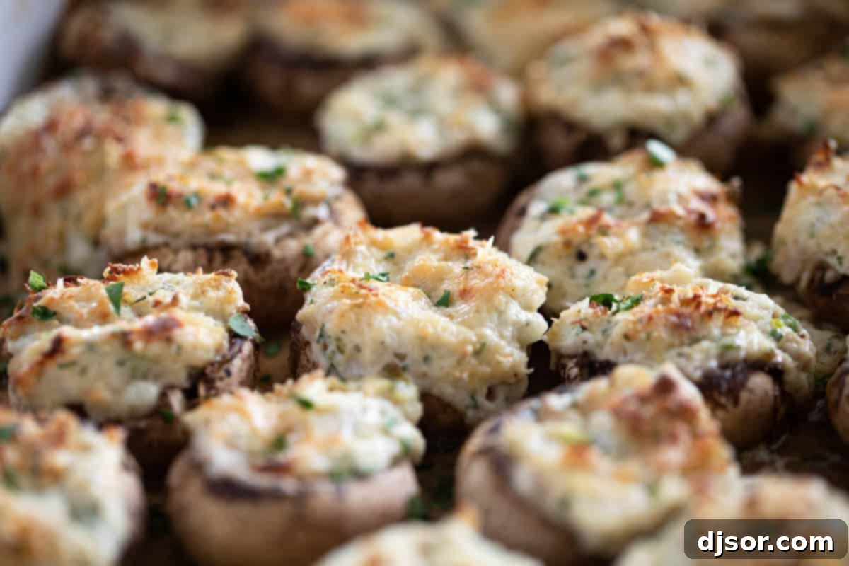 Baked Crab Stuffed Mushrooms glistening in a baking dish, perfectly golden and ready to serve as an impressive appetizer.