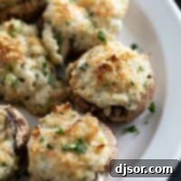 Crab stuffed mushrooms sprinkled with parsley on a plate.