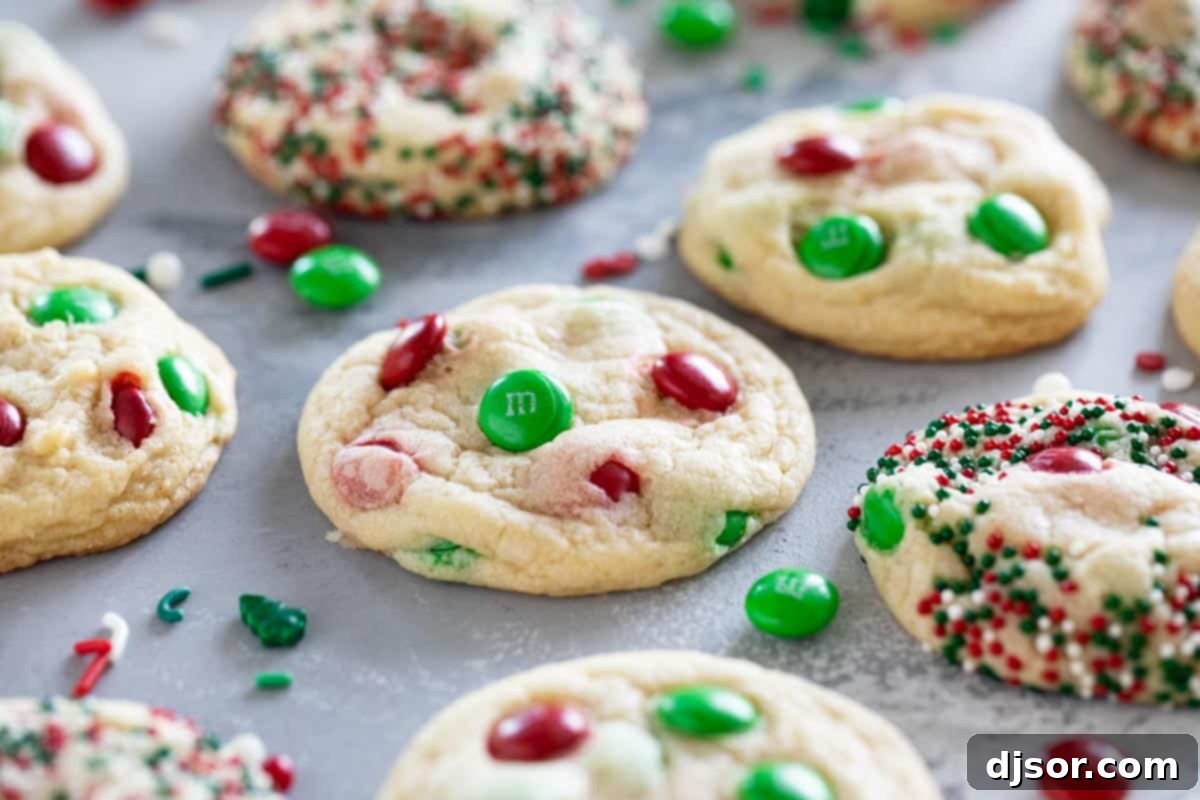 Soft, delicious, and super festive, these Christmas M&M Cookies will be a favorite for both kids and adults. Add sprinkles to make them even more fun! Festive Christmas M&M Cookies adorned with vibrant red and green M&Ms and a scattering of colorful sprinkles, ready for the holidays.