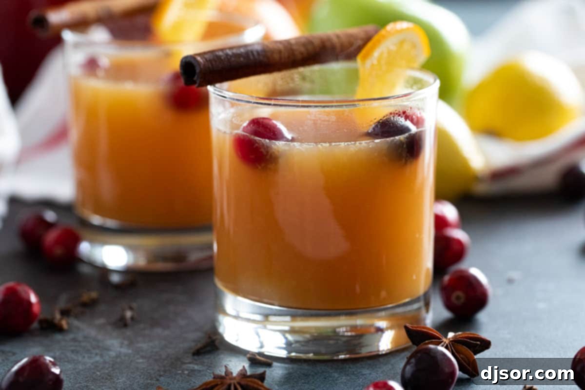 Perfect for winter celebrations or for warming up on a cold night, this hot Wassail Recipe is filled with spices and sweet juice flavors. It’s sweet and spicy and so warm and comforting! Glasses of hot wassail topped with cinnamon sticks and cranberries.