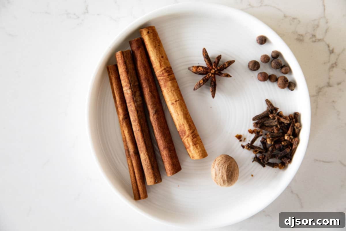 Perfect for winter celebrations or for warming up on a cold night, this hot Wassail Recipe is filled with spices and sweet juice flavors. It’s sweet and spicy and so warm and comforting! Whole spices needed to make homemade hot wassail.