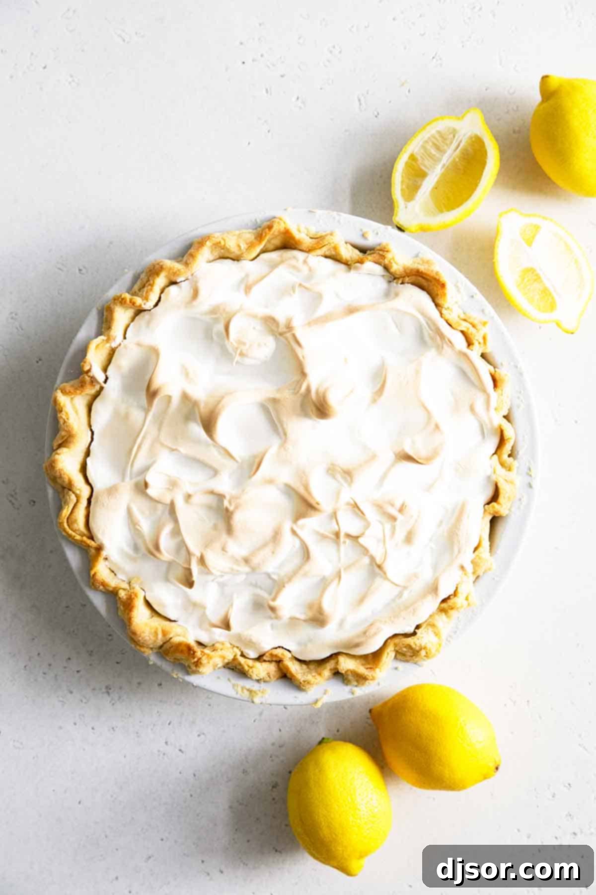 whole lemon meringue pie with lemons